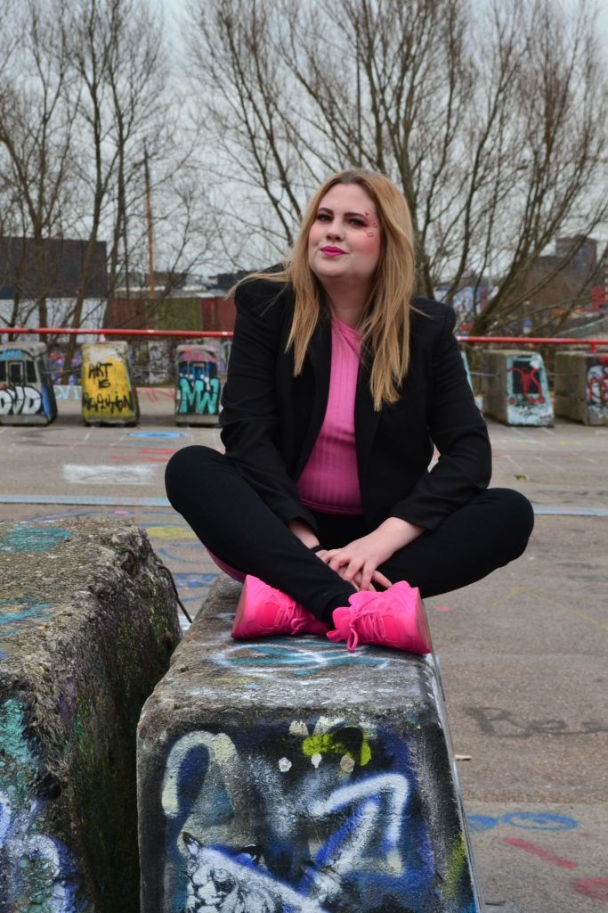 a beautiful girl shows their pink sneakers