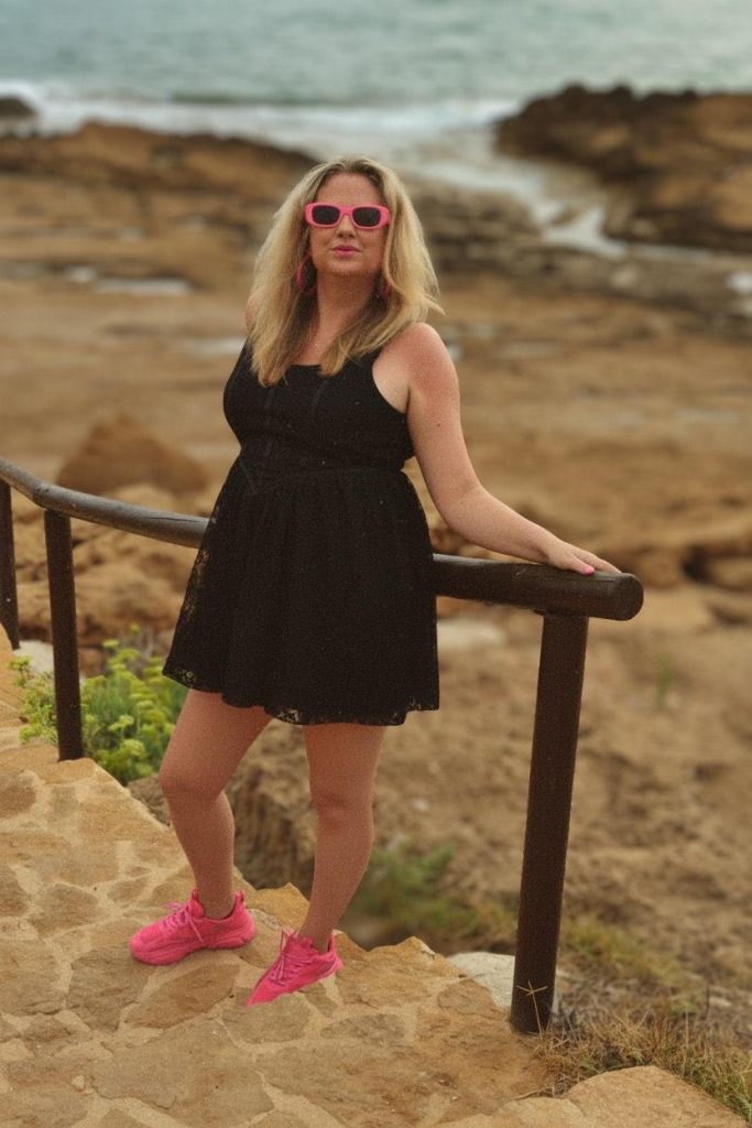 a women shows their black clothes and pink sneakers combination